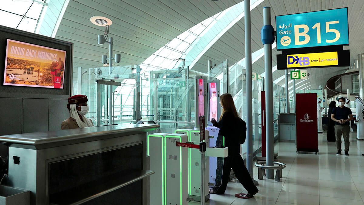 At Dubai airport, travelers' eyes their passports Inside